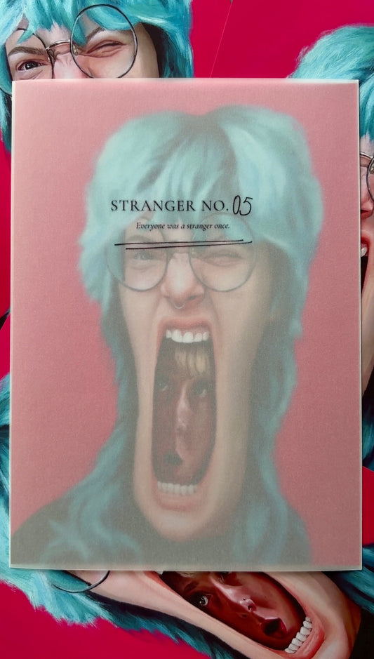 Art print with a stylized face and text 'Stranger No. 05' held by two people with blue hair.